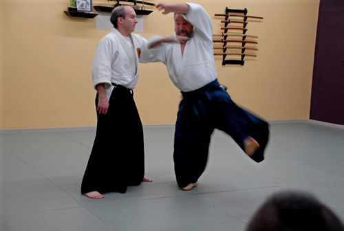 Shihan performs back coat grab technique